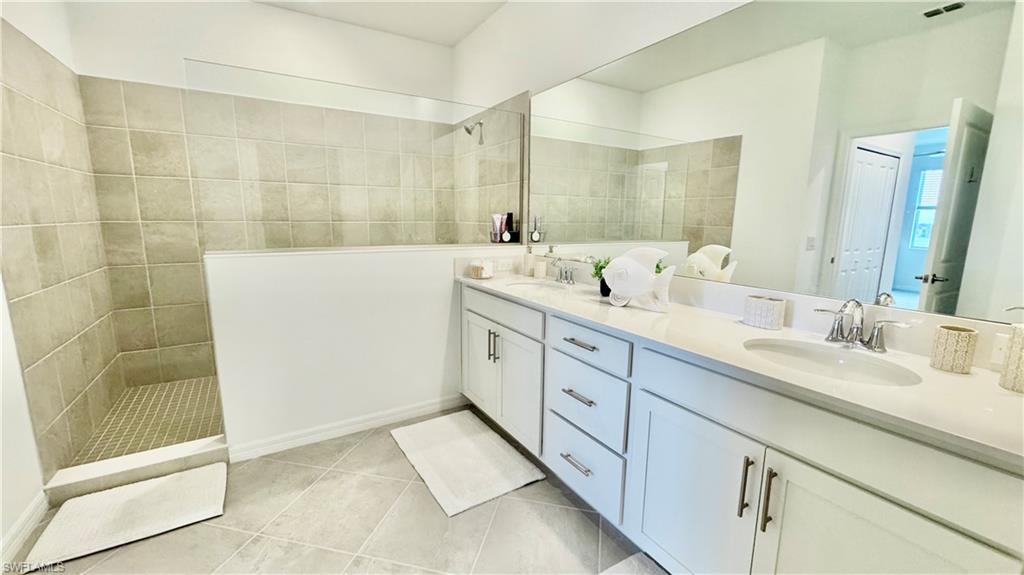 Primary bath with walk-in shower and dual vanity
