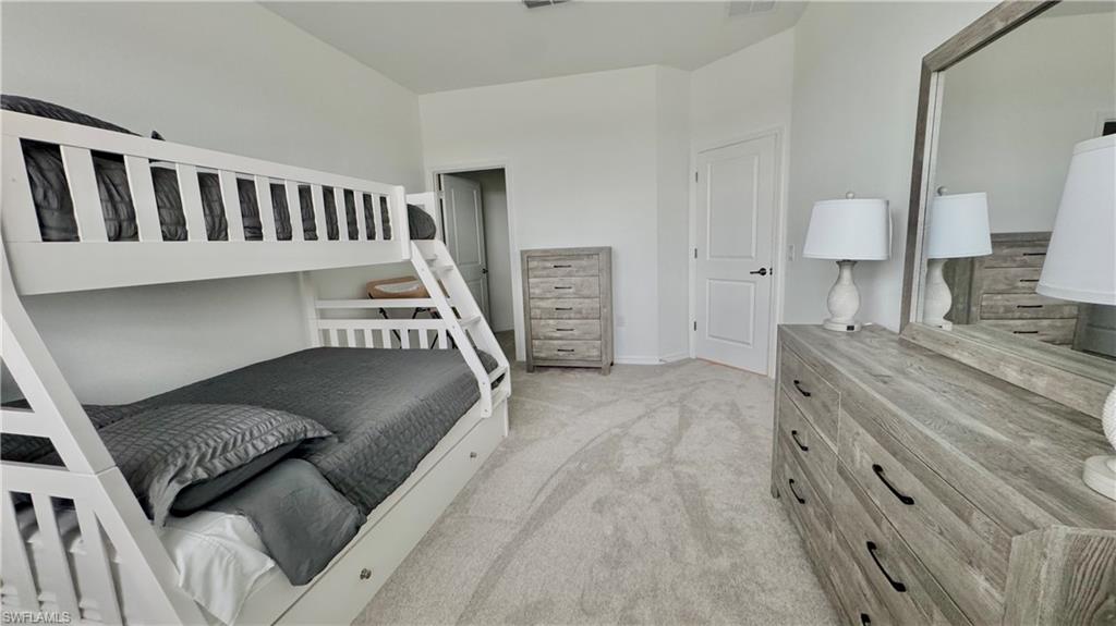 Bunk room with dresser and mirror