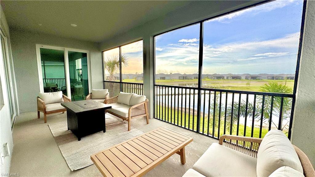 Lanai lounge with fire table and water view