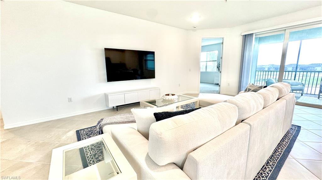 Living room with TV and balcony view